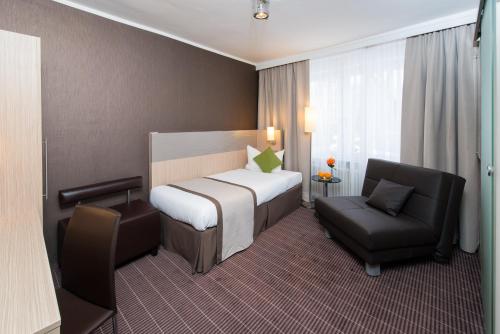 Ένα ή περισσότερα κρεβάτια σε δωμάτιο στο Hotel New Orly
