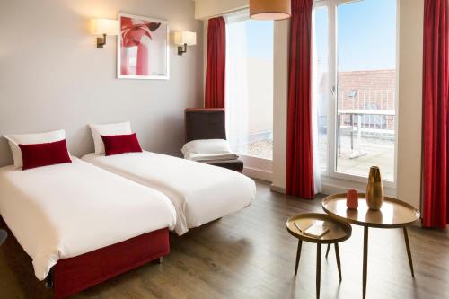 Кровать или кровати в номере Aparthotel Adagio Basel City