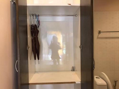 a glass shower door with a persons shadow in a bathroom at KK Lipe Resort in Ko Lipe