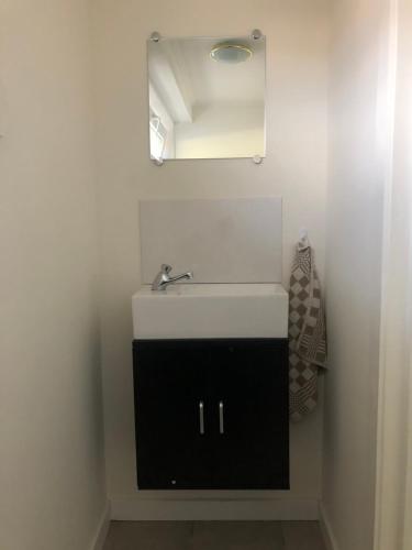 a bathroom with a sink and a mirror at Vivere in Houthalen-Helchteren