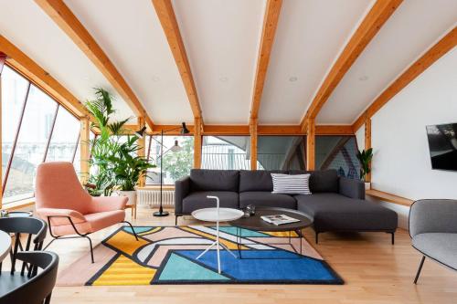 a living room with a couch and a table at Hausd - Piccadilly Circus in London