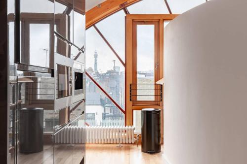 a staircase in a house with a view of the city at Hausd - Piccadilly Circus in London