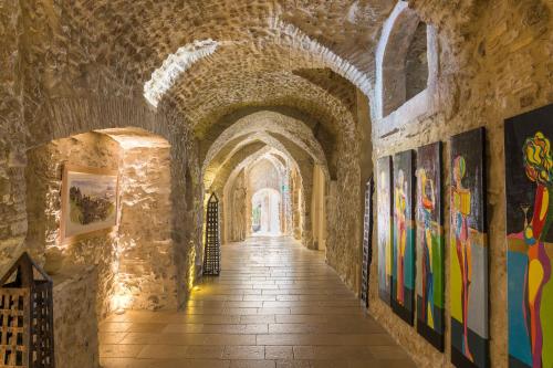 a hallway in a castle with paintings on the walls at Hotel Metropole Taormina in Taormina