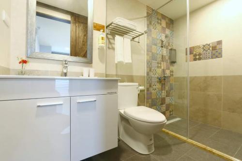 a bathroom with a toilet and a sink and a shower at Lukang Barn Inn in Lugang