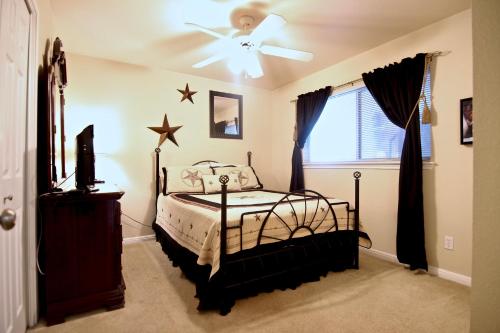 a bedroom with a bed and a ceiling fan at Guadalupe Getaway in New Braunfels