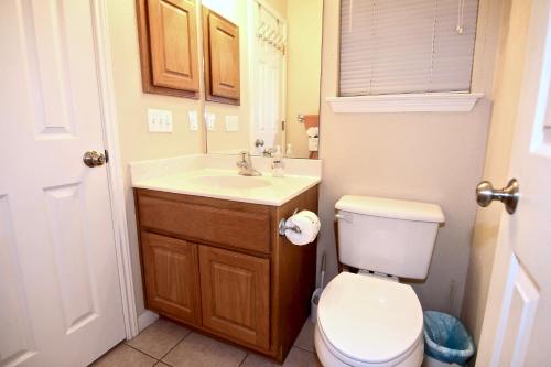a bathroom with a white toilet and a sink at Guadalupe Getaway in New Braunfels