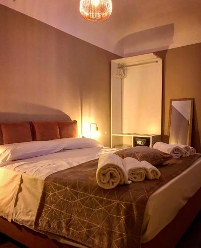 a bedroom with a bed with towels on it at Residenza del Castillo in Palermo
