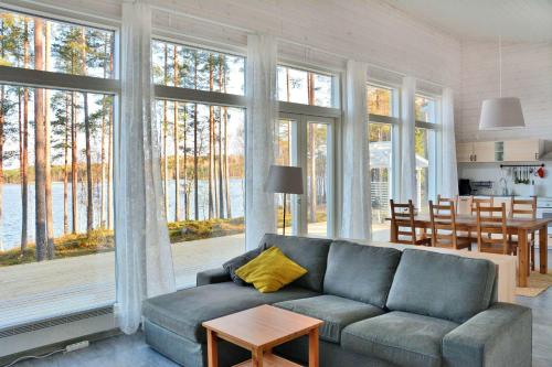 a living room with a blue couch and a table at ONNI Village in Ruokolahti