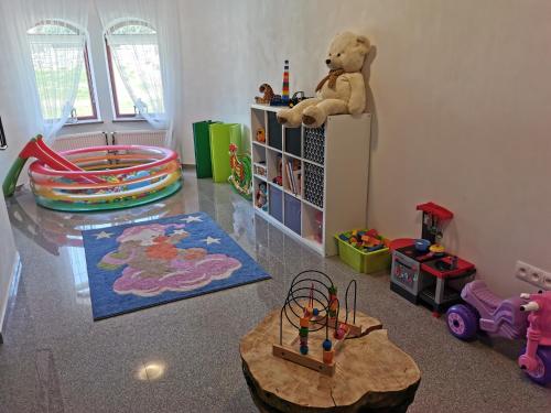 a childs room with a teddy bear sitting on a shelf at Zamoček in Matiašovce