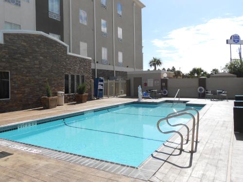 a large swimming pool in front of a building at Holiday Inn Express & Suites Corpus Christi - North by IHG in Corpus Christi