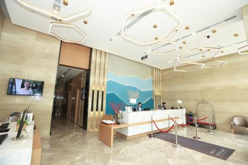 a lobby with a reception desk in a building at Holiday Inn Express Chengdu Xindu by IHG in Chengdu