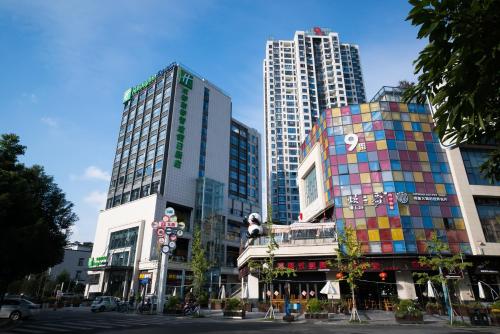 a group of tall buildings in a city at Holiday Inn Express Chengdu Xindu by IHG in Chengdu