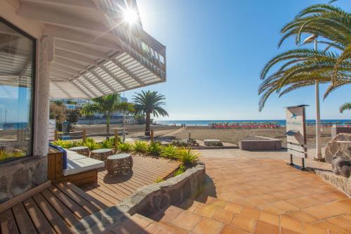 a patio with a view of the beach at Corallium Beach by Lopesan Hotels - Adults Only in San Agustin