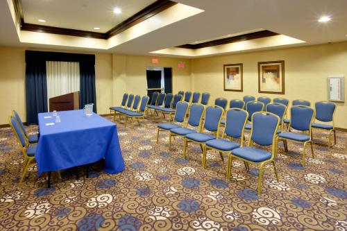 a conference room with a blue table and chairs at Holiday Inn Express Tower Center New Brunswick by IHG in East Brunswick