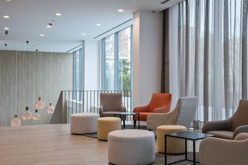 a waiting room with chairs and tables and windows at Acta Voraport in Barcelona