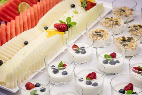 a table topped with glasses of milk and fruit at Acta Voraport in Barcelona