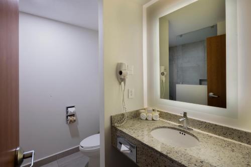 a bathroom with a sink and a toilet and a phone at Holiday Inn Express Puebla, an IHG Hotel in Puebla