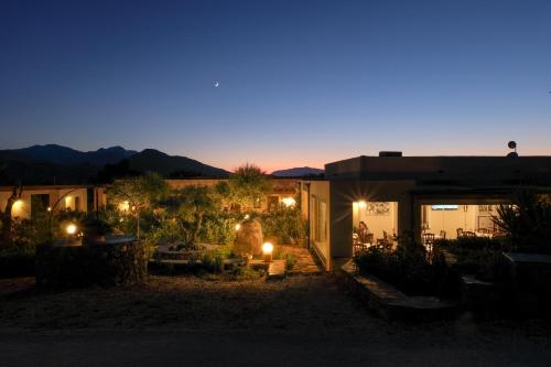 a house with lights in the yard at night at Hotel Barbagia in Dorgali