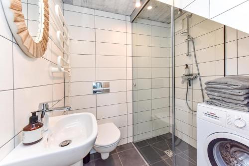 a bathroom with a sink and a washing machine at Stunning Seaside Haus in Palanga