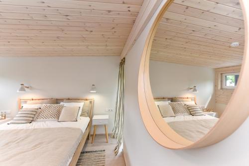 a bedroom with two beds and a mirror at Stunning Seaside Haus in Palanga