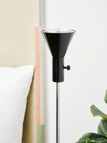 a black floor lamp next to a pillow at Haus im Tal in Munich