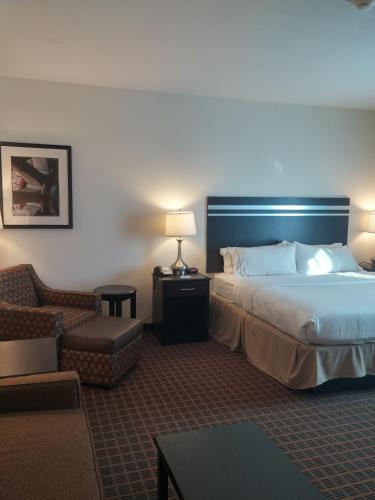 a hotel room with a bed and a chair at Holiday Inn Express & Suites Golden by IHG in Golden