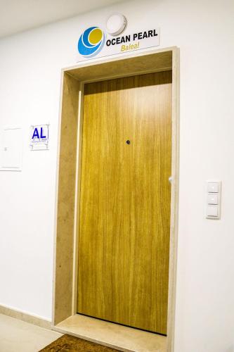 a wooden door in a room with a sign on it at Ocean Pearl Baleal in Ferrel