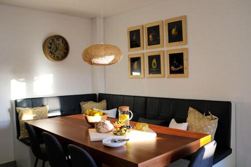 a dining room with a wooden table and chairs at Ocean Pearl Baleal in Ferrel