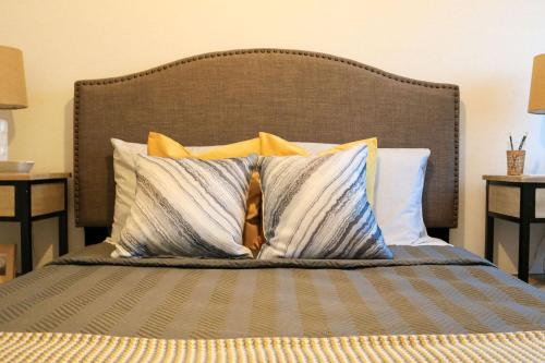 a bed with four pillows on top of it at Ocean Pearl Baleal in Ferrel