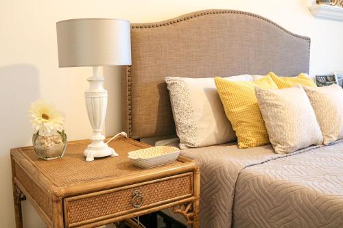 a bed with a table with a lamp on it at Ocean Pearl Baleal in Ferrel