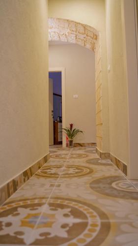 a hallway with a tile floor in a building at Angel's house in Nazareth