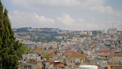 a view of a city with houses and buildings at Angel's house in Nazareth