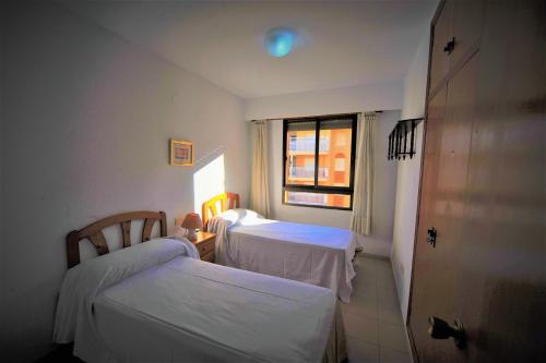 a hospital room with two beds and a window at Apartamento Olimpo Orange Costa in Benicàssim
