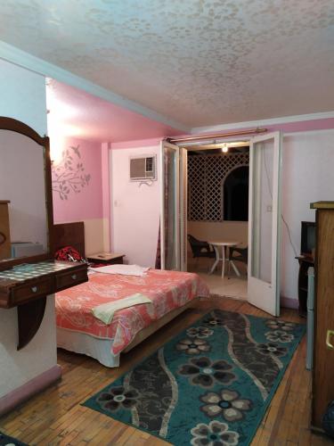 a bedroom with a bed and a table and a room with a table at Cairo Moon Hostel in Cairo