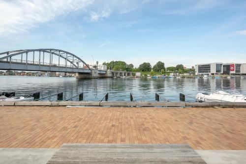 a bridge over a river with boats in the water at Harbour Penthouse in Sønderborg