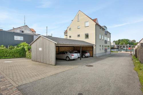 a car parked in a garage next to a building at Harbour Penthouse in Sønderborg