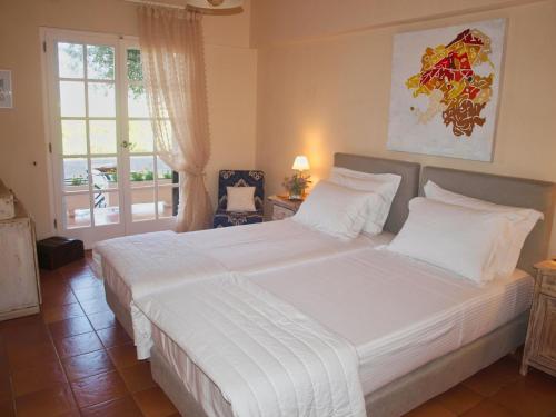 a large white bed in a bedroom with a window at Penelope Dream Pool Villa in Minia