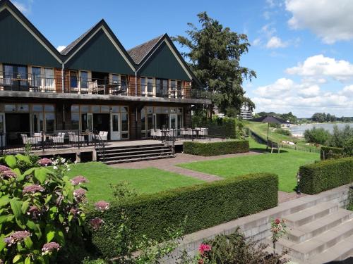 a large house with a lawn in front of it at Villa Veertien in Dieren