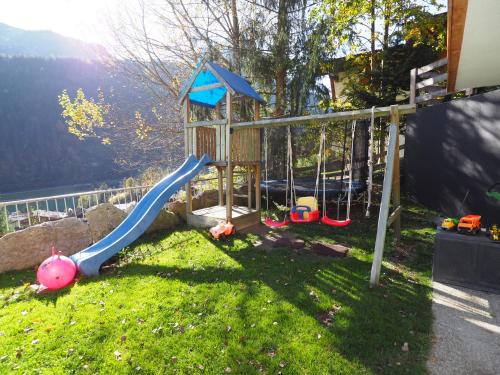 a playground with a slide in the grass at Ferienwohnung Widkal in Finkenberg