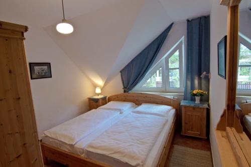 a small bedroom with a bed in a attic at Haus Seeblick-Binz in Binz