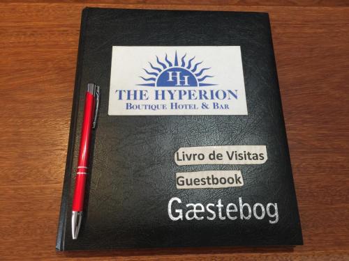 a red pen sitting on top of a book at The Hyperion Boutique Hotel in Florianópolis
