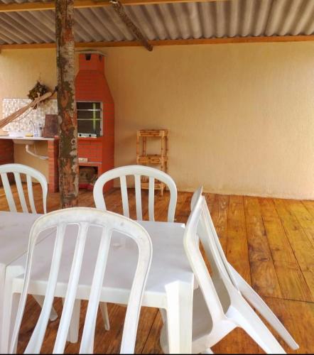 a white table and chairs in a room at Pousada Ilha Sul in Cananéia