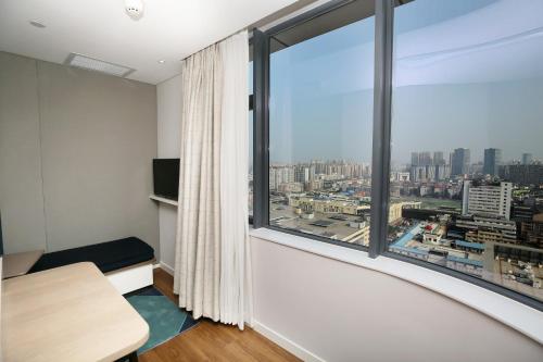 a room with a large window with a city view at Holiday Inn Express Chengdu North Railway Station, an IHG Hotel in Chengdu