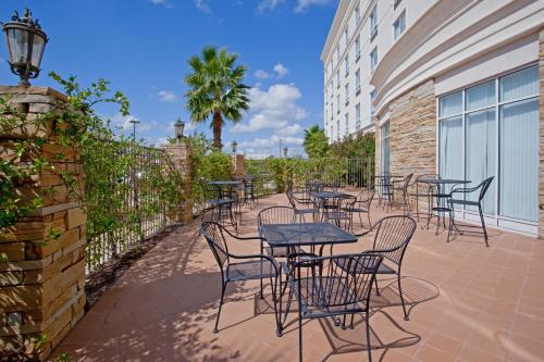 a row of tables and chairs on a patio at Holiday Inn & Suites College Station-Aggieland by IHG in College Station