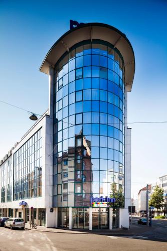 a large glass building with a lot of windows at Park Inn by Radisson Nürnberg in Nuremberg
