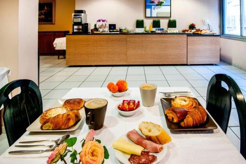 a table with two trays of food on it at Hôtel Christ Roi in Lourdes
