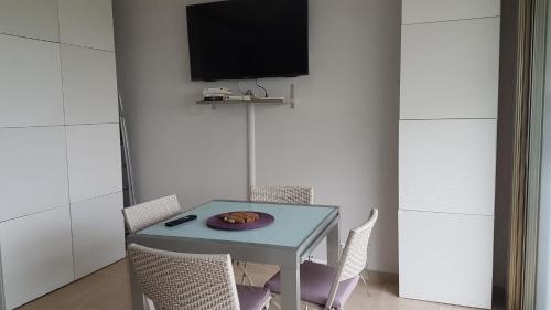 a table with chairs and a plate with a donut on it at Lovely apartment in Marina Baie des Anges- Baronnet - Sew view, free parking spaces on site, restaurants, beach, supermarket in Villeneuve-Loubet