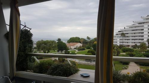 a window with a view of a city at Lovely apartment in Marina Baie des Anges- Baronnet - Sew view, free parking spaces on site, restaurants, beach, supermarket in Villeneuve-Loubet