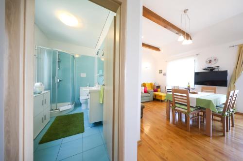 a kitchen and living room with a table and a dining room at Apartment Milka with sea view in Tisno