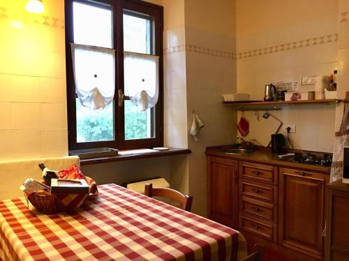 a kitchen with a table with a checkered table cloth at Tenuta Calabiana in Diano dʼAlba